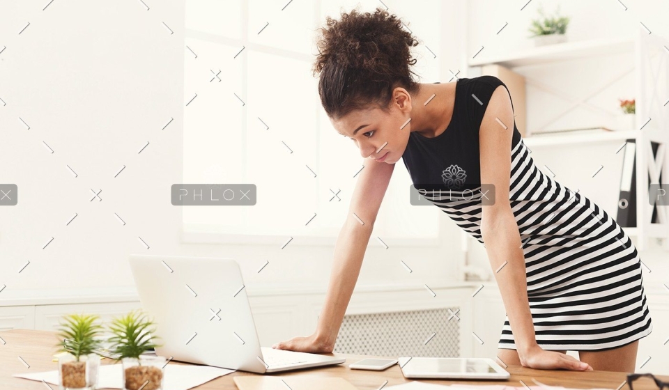 demo-attachment-115-business-woman-working-on-laptop-at-office-PRFJKQJ